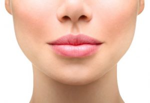 A close up image of a woman's bottom half of the face. She received lip fillers.