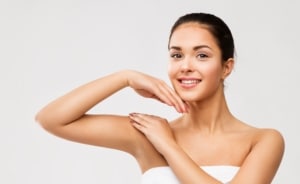 A woman showing sculpted arms after arm reduction surgery